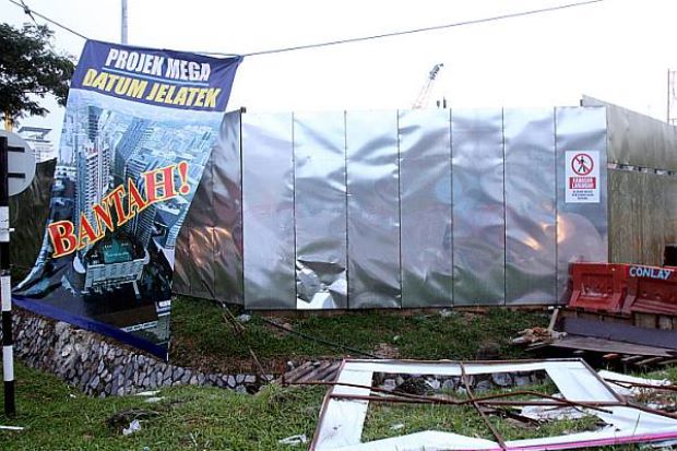 The damaged billboard of the Datum Jelatek Project is seen following a demonstration by a group of residents in Taman Keramat, Kuala Lumpur recently.